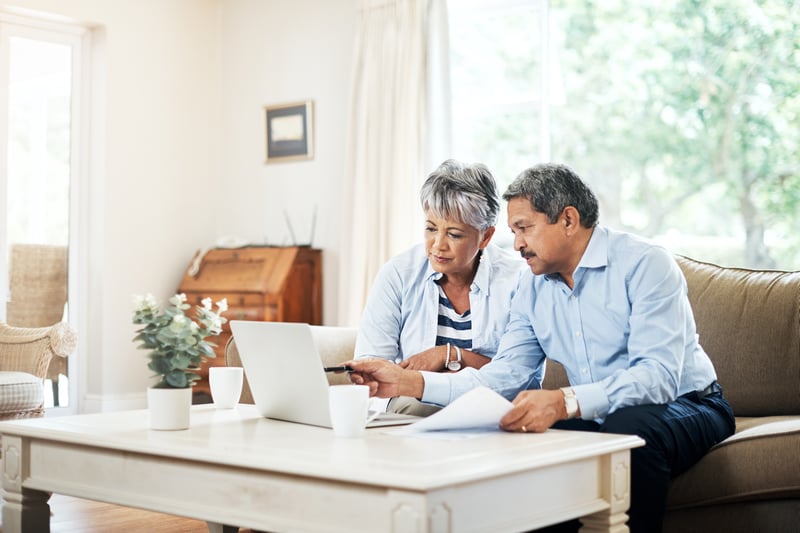 couple working on laptop looking at retirement plans